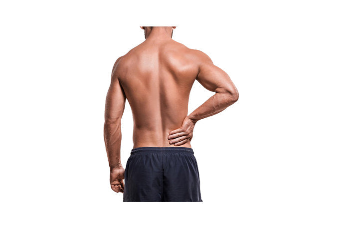 Image of shirtless man with hand on lower back.